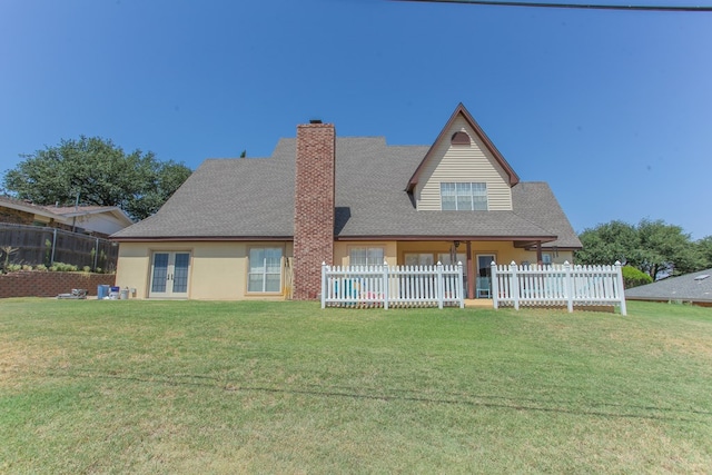 rear view of property with a yard and french doors