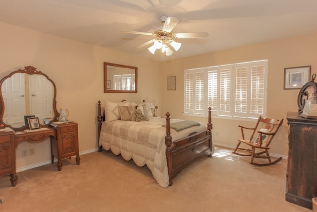 bedroom featuring ceiling fan and light carpet