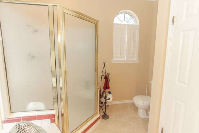 bathroom with toilet, tile patterned floors, and walk in shower