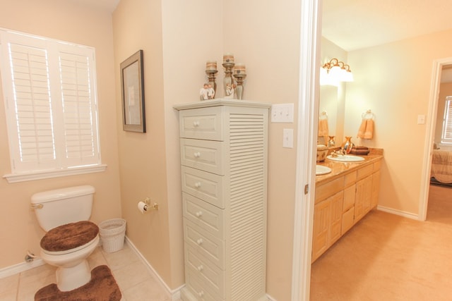 bathroom with tile patterned floors, vanity, and toilet