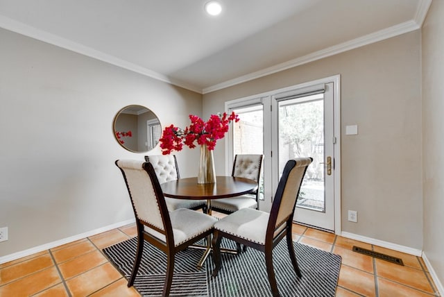 dining area featuring light tile patterned floors and ornamental molding