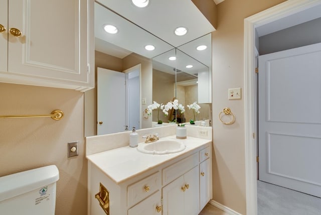 bathroom featuring vanity and toilet