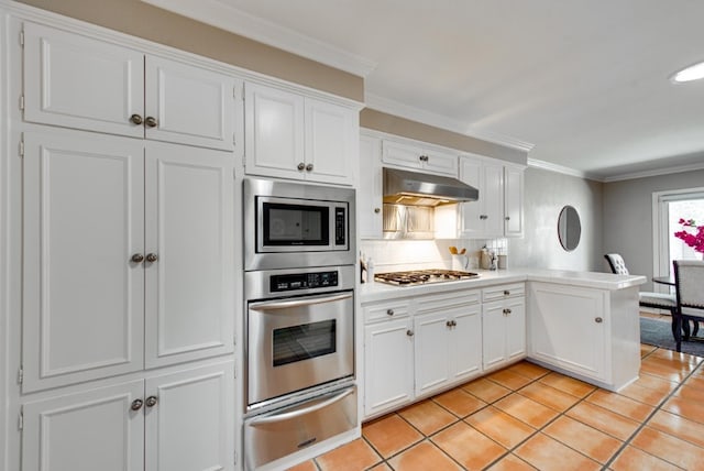 kitchen with white cabinetry, light tile patterned floors, stainless steel appliances, and ornamental molding