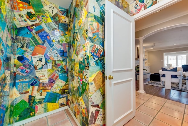 bathroom with tile patterned flooring, ornate columns, and ornamental molding