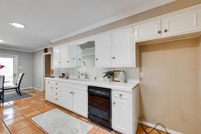 kitchen with dishwasher, white cabinetry, sink, and tasteful backsplash