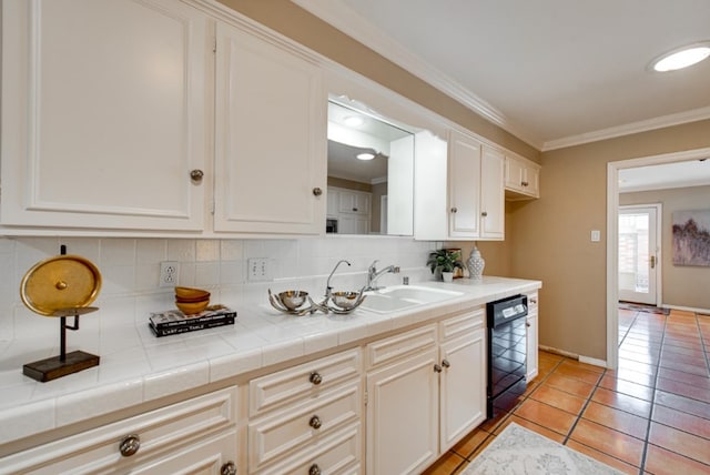 kitchen featuring white cabinetry, dishwasher, tile counters, sink, and ornamental molding