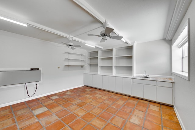 kitchen with ceiling fan, sink, white cabinets, and light tile patterned flooring