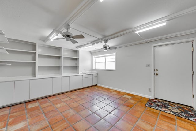 interior space featuring ceiling fan, light tile patterned flooring, and sink