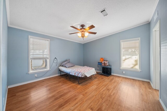 unfurnished bedroom with ceiling fan, light hardwood / wood-style flooring, and a textured ceiling