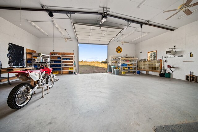 garage with a workshop area and ceiling fan