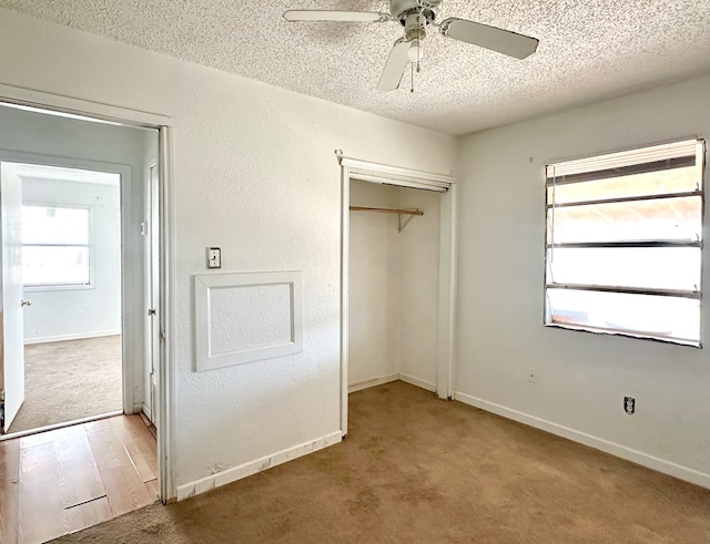 unfurnished bedroom with a closet, light carpet, and a textured ceiling