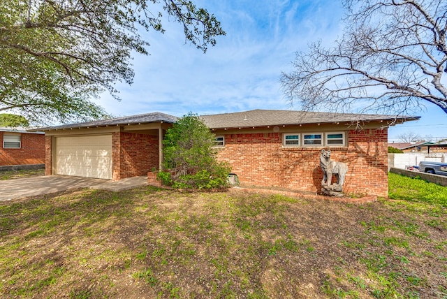 ranch-style home with brick siding, driveway, and a garage