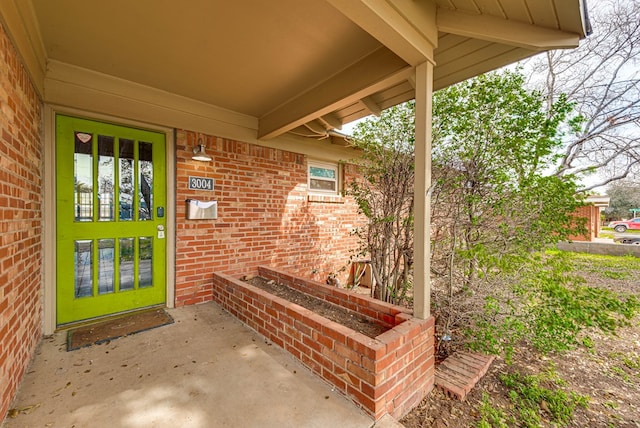 entrance to property with brick siding