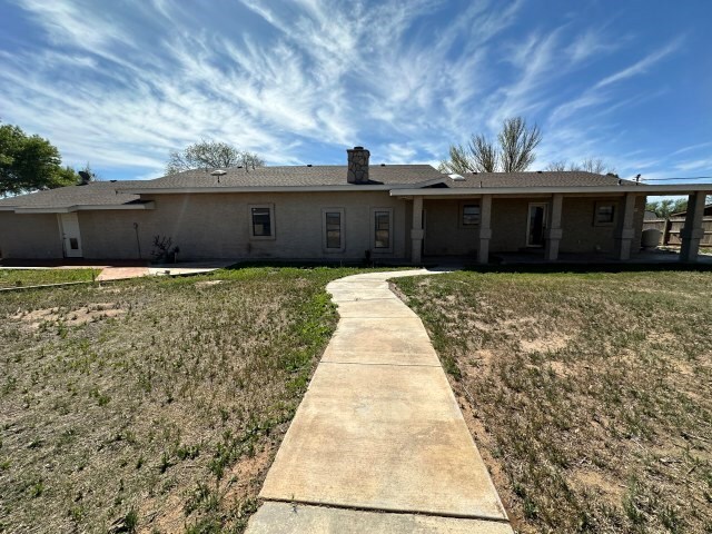 back of house featuring a yard