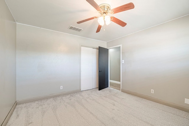 empty room with ceiling fan and light colored carpet