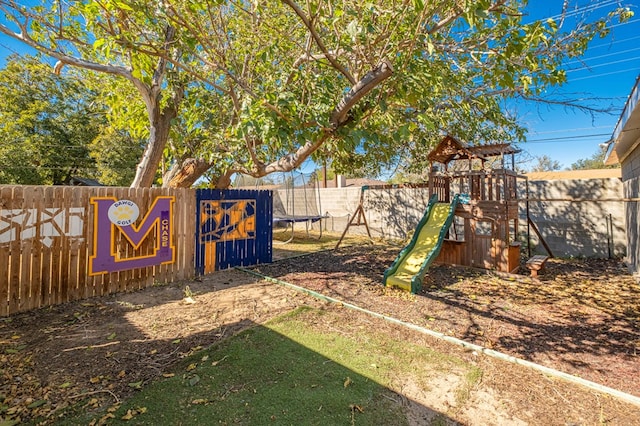 view of yard featuring a playground and a trampoline