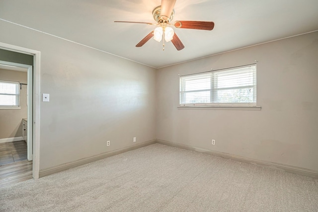 carpeted empty room featuring ceiling fan