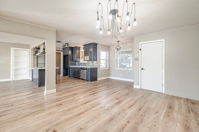 kitchen with backsplash, dishwasher, light hardwood / wood-style flooring, and hanging light fixtures