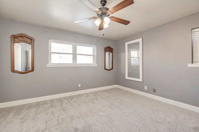 empty room featuring carpet flooring and ceiling fan