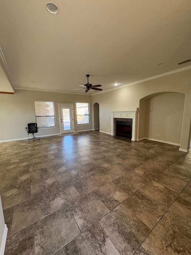 unfurnished living room featuring ceiling fan and ornamental molding