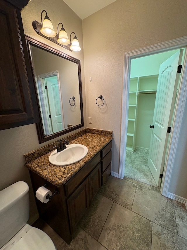 bathroom featuring toilet and vanity