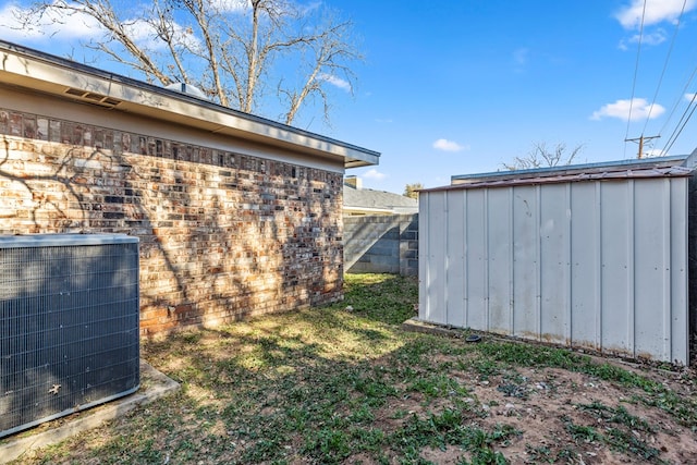 exterior space featuring central AC and a storage shed