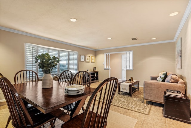 tiled dining area featuring crown molding