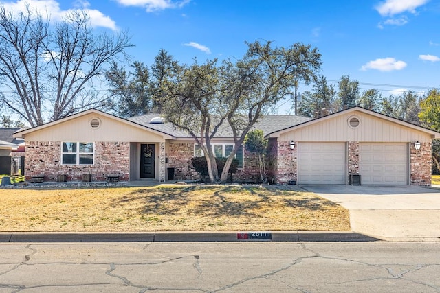 ranch-style home featuring a garage and a front yard