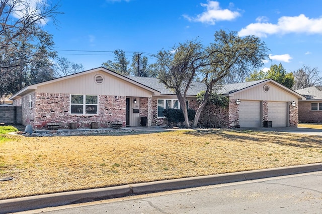 single story home with a garage and a front lawn