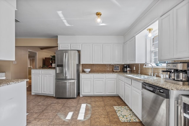 kitchen featuring white cabinetry, appliances with stainless steel finishes, sink, and decorative backsplash