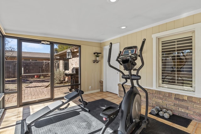 exercise area featuring crown molding