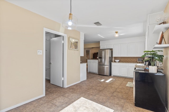 kitchen featuring stainless steel refrigerator with ice dispenser, white cabinetry, decorative light fixtures, and tasteful backsplash