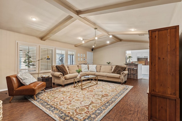 living room with dark wood-type flooring, an inviting chandelier, and lofted ceiling with beams