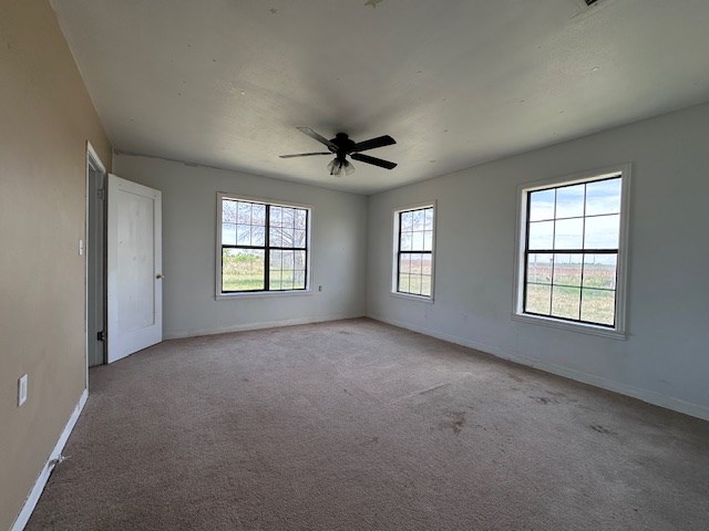 999 S County Rd 183, Snyder, TX 79549 - carpeted empty room with baseboards and ceiling fan