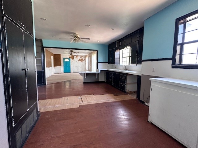 999 S County Rd 183, Snyder, TX 79549 - kitchen featuring light countertops, a sink, a kitchen bar, a peninsula, and a ceiling fan