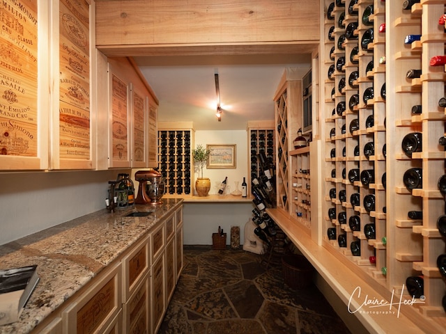 1509 Bedford Dr, Midland, TX 79701 - wine area featuring a sink and dark stone finish flooring