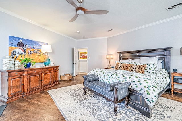 bedroom featuring dark hardwood / wood-style flooring, ceiling fan, crown molding, and a textured ceiling