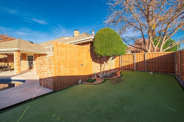 view of yard with a patio area and a swimming pool