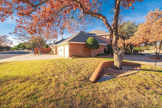 view of front of home with a front yard and a garage