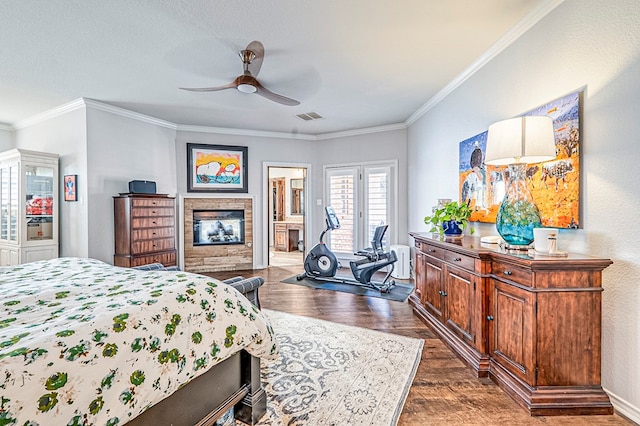 bedroom featuring ceiling fan, ornamental molding, dark wood-type flooring, and connected bathroom