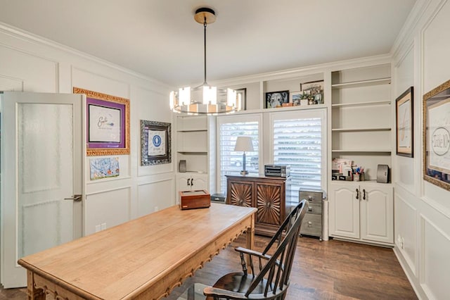 home office with built in features, dark hardwood / wood-style flooring, ornamental molding, and an inviting chandelier