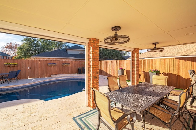 view of patio with a fenced in pool and ceiling fan