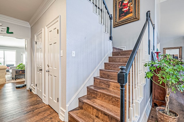 staircase featuring hardwood / wood-style floors and crown molding