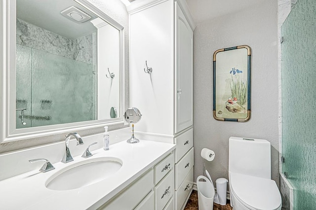 bathroom featuring vanity, toilet, and a shower with shower door