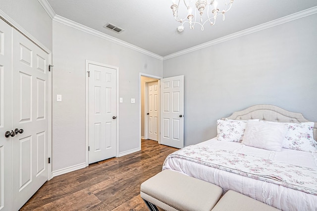 bedroom with crown molding, dark wood-type flooring, and a chandelier