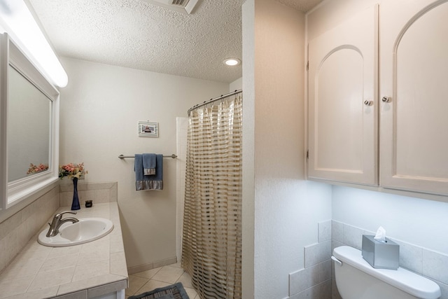 1115 Gulf Ave, Midland, TX 79705 - bathroom with toilet, tile patterned flooring, a textured ceiling, vanity, and curtained shower