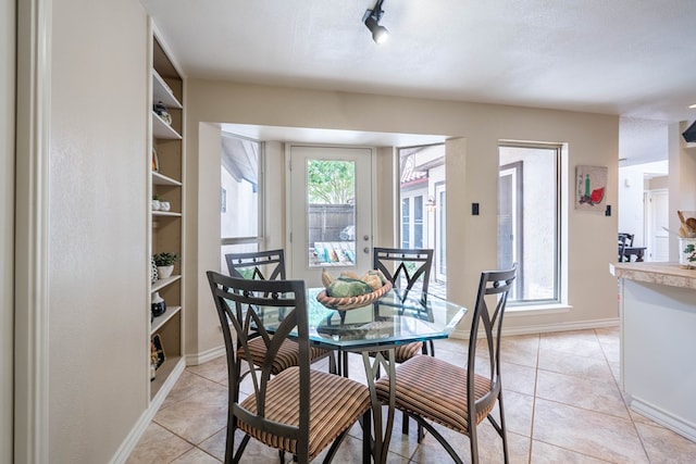 1115 Gulf Ave, Midland, TX 79705 - dining area featuring baseboards and light tile patterned flooring