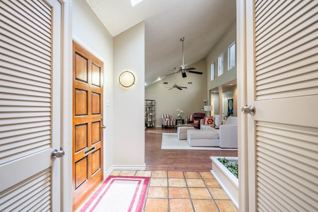 1115 Gulf Ave, Midland, TX 79705 - entryway with a ceiling fan, lofted ceiling, baseboards, and light tile patterned floors