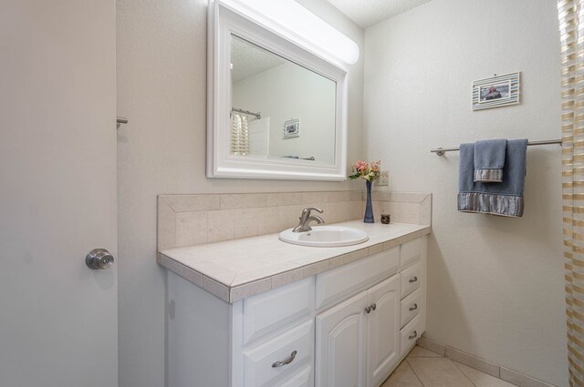 1115 Gulf Ave, Midland, TX 79705 - full bathroom featuring tile patterned floors, vanity, and tasteful backsplash