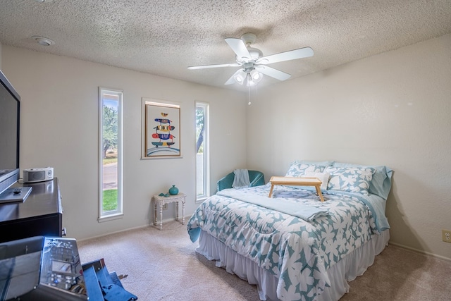 1115 Gulf Ave, Midland, TX 79705 - carpeted bedroom featuring a textured ceiling, ceiling fan, and baseboards